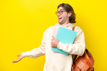 Young student handsome man isolated on yellow background with surprise expression while looking side