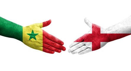 Handshake between England and Senegal flags painted on hands, isolated transparent image.