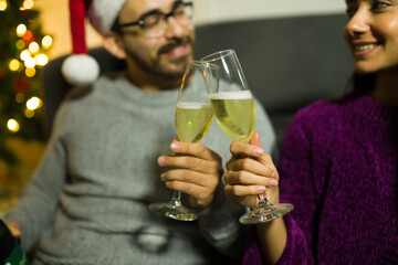 Couple making a toast with champagne celebrating christmas