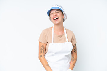 Fishmonger wearing an apron and holding a raw fish isolated on white background laughing