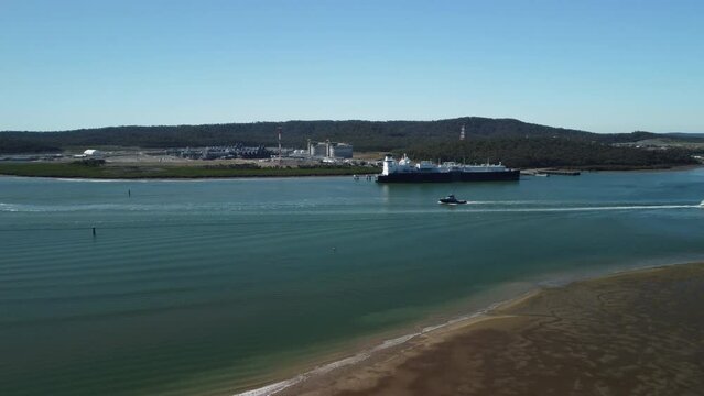 Aerial view over water approaching Curtis Island gas export terminal, Queensland