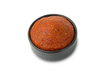 Thai red curry paste in black bowl isolated on white background with clipping path