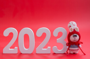 Knitted bunny with numbers 2023 New Year and Christmas. Copy space