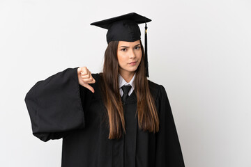 Teenager Brazilian university graduate over isolated white background showing thumb down with negative expression