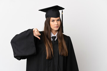 Teenager Brazilian university graduate over isolated white background showing thumb down with...