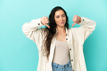 Young caucasian woman isolated on blue background proud and self-satisfied