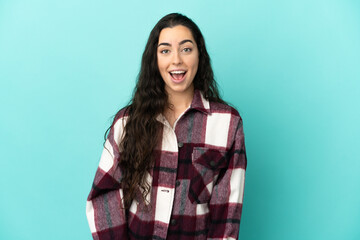 Fototapeta premium Young caucasian woman isolated on blue background with surprise facial expression