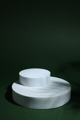 Product photography props. Round shaped podiums on green background, space for text