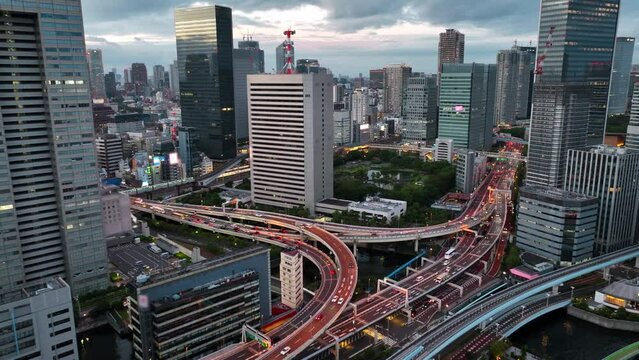 flying above central Tokyo, Japan, busy traffic on Japanese highway, metropolis lifestyle, urban central Tokyo, drone view of Tokyo skyscrapers in the evening