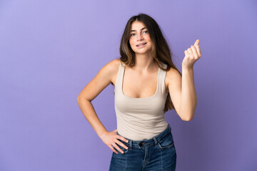 Young caucasian woman isolated on purple background making Italian gesture