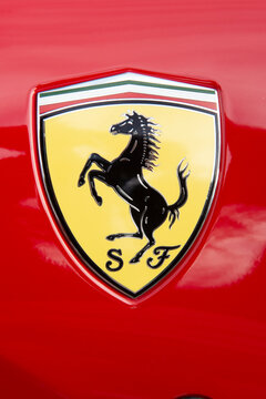 Close up of Scuderia Ferrari symbol (Cavallino rampant) of a parked red Ferrari