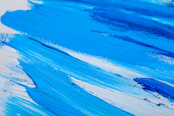 Beautiful strokes of blue oil paints on white canvas as background, closeup