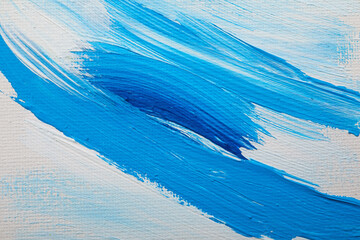 Beautiful strokes of blue oil paints on white canvas as background, closeup