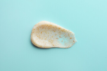 Sample of face scrub on light blue background, top view