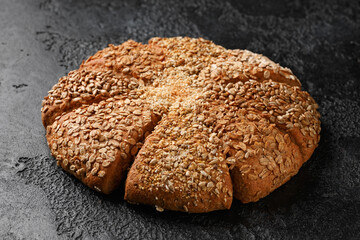 Fresh Homemade seeded share bread on rustic dark background