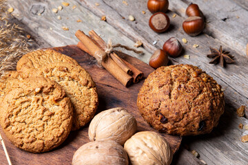 Bran bread, cookies and nuts on a wooden table. A healthy and wholesome breakfast.