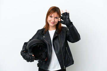 Redhead girl with a motorcycle helmet isolated on white background showing ok sign with fingers