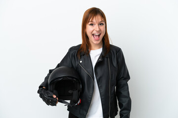 Redhead girl with a motorcycle helmet isolated on white background with surprise facial expression