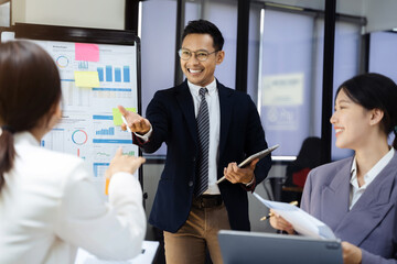 Male Operations Manager Holds Meeting Presentation for analysis graph company financial. People Work in Business Office.