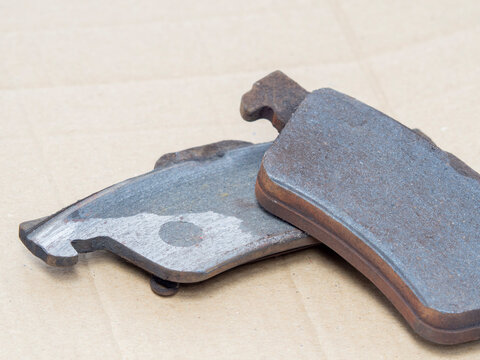 Used damaged brake pads need to change, close up.