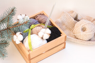 balls of thread in a wooden box folded in tones. Wool yarn