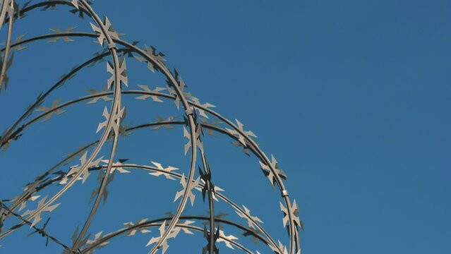 Barbed wire fencing. Border wall between countries. Barbed wire fencing around a prison. Conflict between countries.