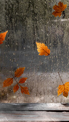 Raindrops and fallen leaves on the window. The weather is typical autumn. Autumn window background.