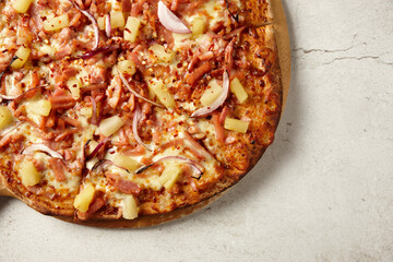 Gourmet wood fired ham and pineapple pizza on table