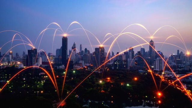 Smart digital city with connection network reciprocity over the cityscape . Concept of future smart wireless digital city and social media networking systems that connects people within the city .