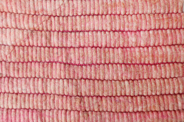 Pink wool yarn cloth background. Surface of fabric texture in white winter color. 