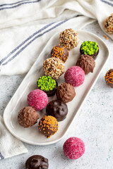 Chocolate praline. Variety of chocolates in bowl on gray background. close up