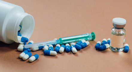syringe with needle, vial and pills with steroids. illegal doping in sport concept
