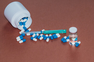 syringe with needle, vial and pills with steroids. illegal doping in sport concept