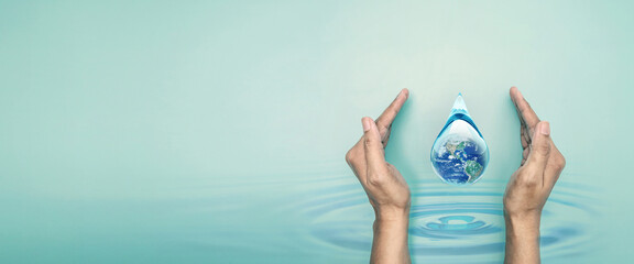 Hand hold world in clean water drop on and fresh blue water ripples design, Environment save and ecology theme and world water day concept, the Elements of this image furnished by NASA - 538599773