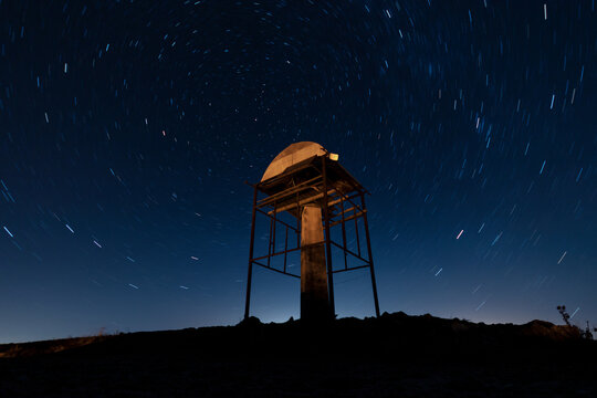 Night sky, a lonely building among the mountains