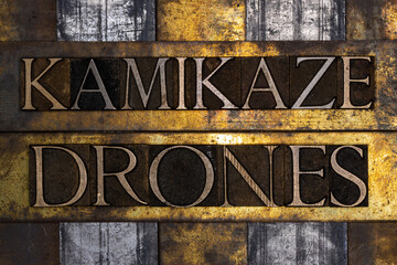 Kamikaze Drones text on grunge textured copper and gold background
