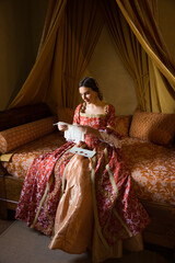 Renaissance lady on silk bed - obrazy, fototapety, plakaty