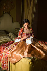 Renaissance woman on golden bed © Anneke