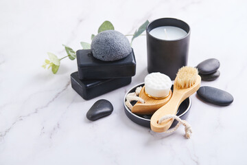 Three pieces of black charcoal soap, Konjac sponge, beauty care products, candles and brushes for...
