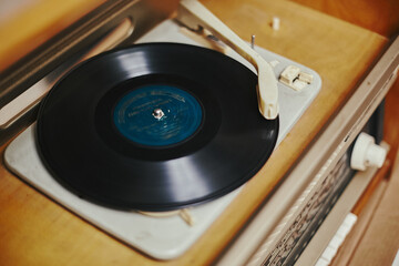 Istra, Russia - September 06, 2021: Vinyl record, spinning on a turntable, Vintage record player with radio 60's.