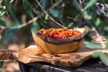 Fotobehang Hot spicy chili pepers. Close up of dried red dry chili pepers in a wooden bowl. Hot chili pepers for seasoning. © devmarya