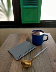 coffee and notebook on the table