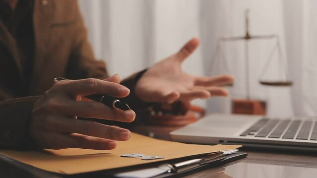 Business and lawyers discussing contract papers with brass scale on desk in office. Law, legal services, advice, justice and law concept picture with film grain effect