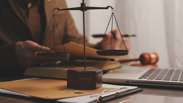 Business and lawyers discussing contract papers with brass scale on desk in office. Law, legal services, advice, justice and law concept picture with film grain effect