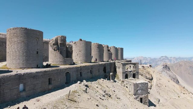 aerial scenic view of ruined artillery batteries with people (515a Batteria Guardia alla Frontiera), Mont Chaberton peak