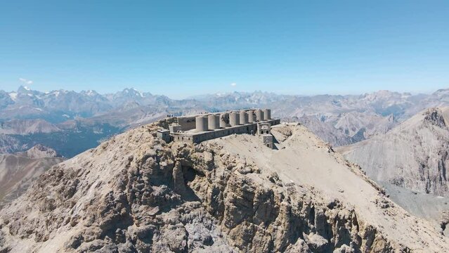 aerial scenic view of ruined artillery batteries with people (515a Batteria Guardia alla Frontiera), Mont Chaberton peak
