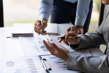 Business executives analyze data documents and calculating about fee tax at an office Image of...