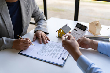 Real estate agents and new homeowners sign home sales or lease agreements. Ready to sign a home or office loan agreement