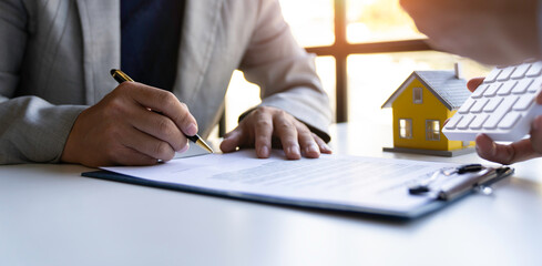Real estate agents and new homeowners sign home sales or lease agreements. Ready to sign a home or...