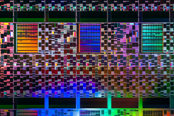 Silicon semiconductor wafer in rainbow light, macro shot showing components of process equipment processor chips